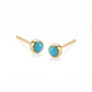 Pair of 18K yellow gold stud earrings featuring bezel-set round bright blue turquoise cabochons.