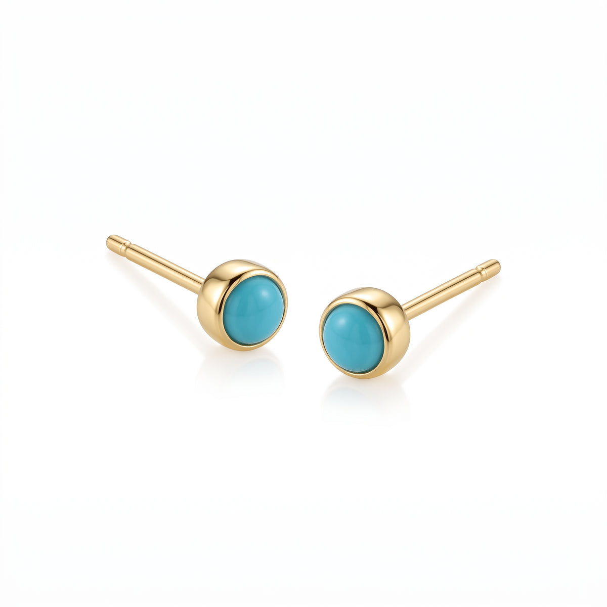 Pair of 18K yellow gold stud earrings featuring bezel-set round bright blue turquoise cabochons.