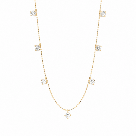 A delicate 18K yellow gold fine jewelry station necklace showcasing nine symmetrically spaced, brilliant-cut natural diamonds totaling 0.75 carats, isolated against a solid white background.