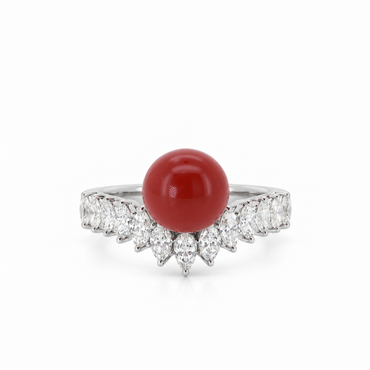 Front view of an 18K white gold statement ring showcasing a vibrant AKA red coral center stone accented with a contoured marquise diamond setting.