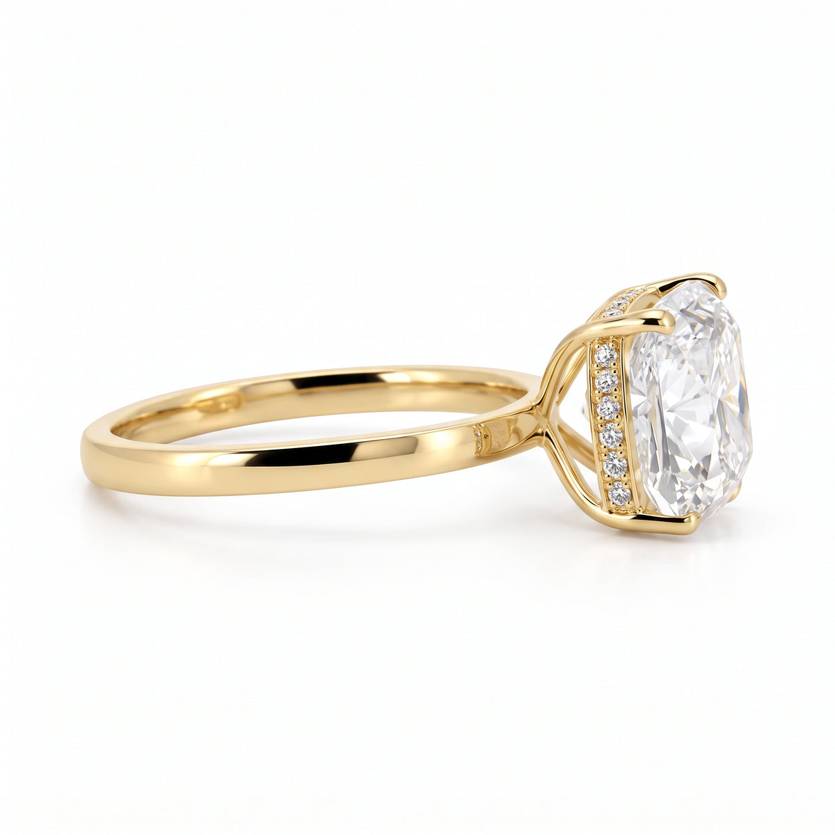 Side profile of a 14K yellow gold engagement ring highlighting the four-prong setting, the hidden halo with pavé diamonds, and the depth of the 3.08-carat cushion modified brilliant diamond.