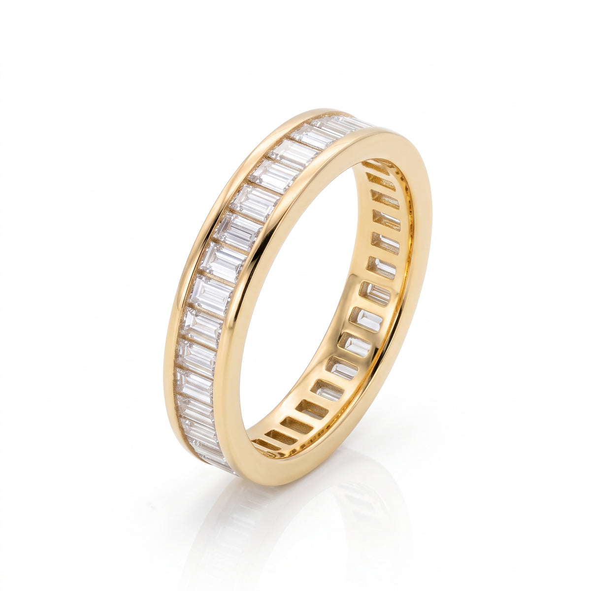 Angled view of an 18K yellow gold linea baguette diamond band, showing the continuous channel setting of lab-grown diamonds.
