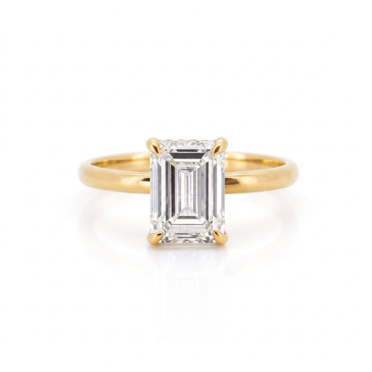 Front view of a 3.28-carat emerald cut lab-grown diamond ring set in an 18K solid yellow gold band.
