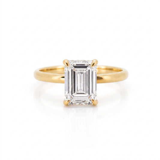 Front view of a 3.28-carat emerald cut lab-grown diamond ring set in an 18K solid yellow gold band.