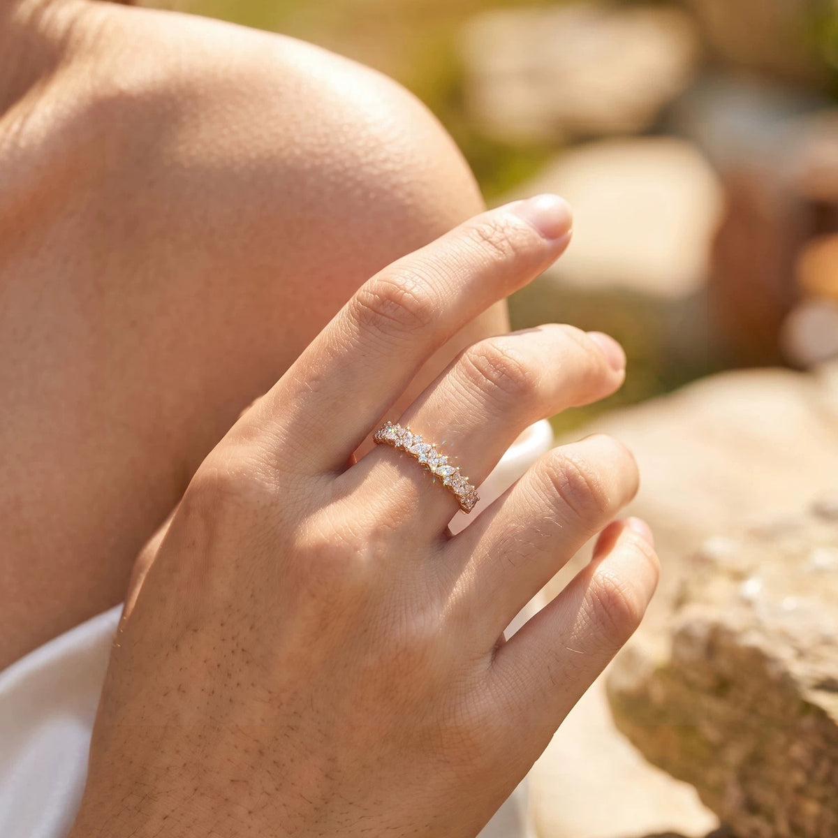 Close-up of a 14K yellow gold lab-grown diamond band on a finger, showing the marquise and round diamond leaf pattern.