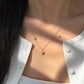 18K yellow gold necklace featuring two asymmetrical diamond-set flower charms on a fine cable chain with an adjustable spring-ring closure.