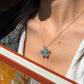 Alt Text: > Large floral pendant featuring five natural blue-green opals set in 18K yellow gold with diamond accents on a gold ball chain.