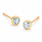 Pair of 18K yellow gold stud earrings featuring bezel-set round light blue aquamarine gemstones.