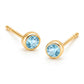 Pair of 18K yellow gold stud earrings featuring bezel-set round light blue topaz gemstones.
