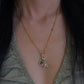 18K gold natural emerald and diamond pendant paired with an 18K gold natural diamond star pendant, styled together on a versatile 18K gold diamond chain.
