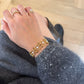 18K gold bracelet featuring lustrous white pearls, natural ruby and sapphire accents, and sparkling natural diamond details in an elegant geometric link design.