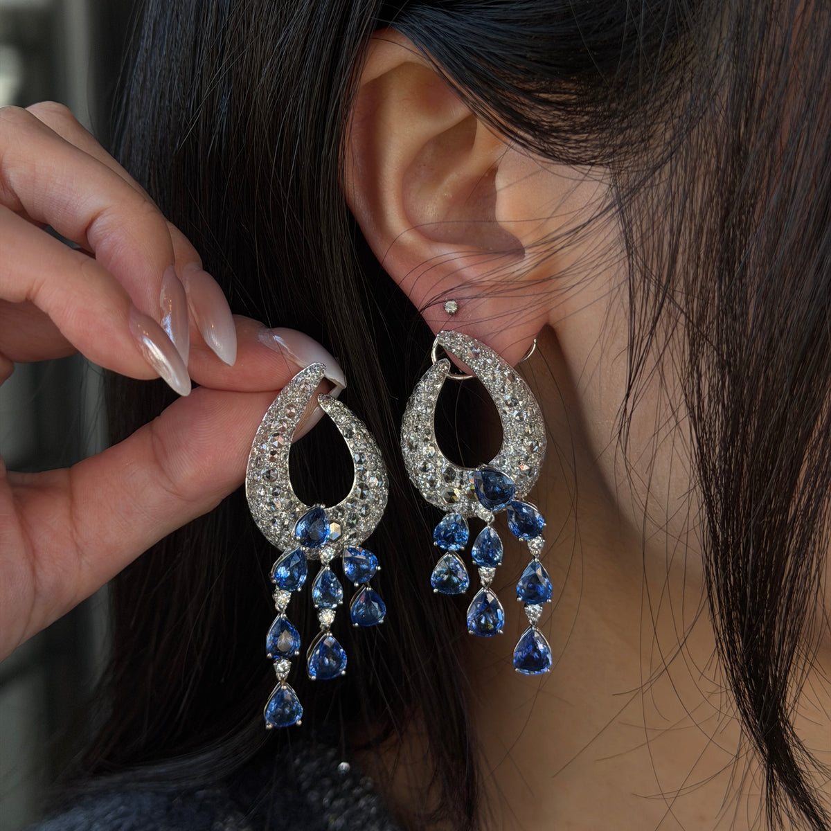18K gold natural sapphire and diamond statement earrings featuring pear-shaped blue sapphires with cascading drops and sparkling natural diamond accents.