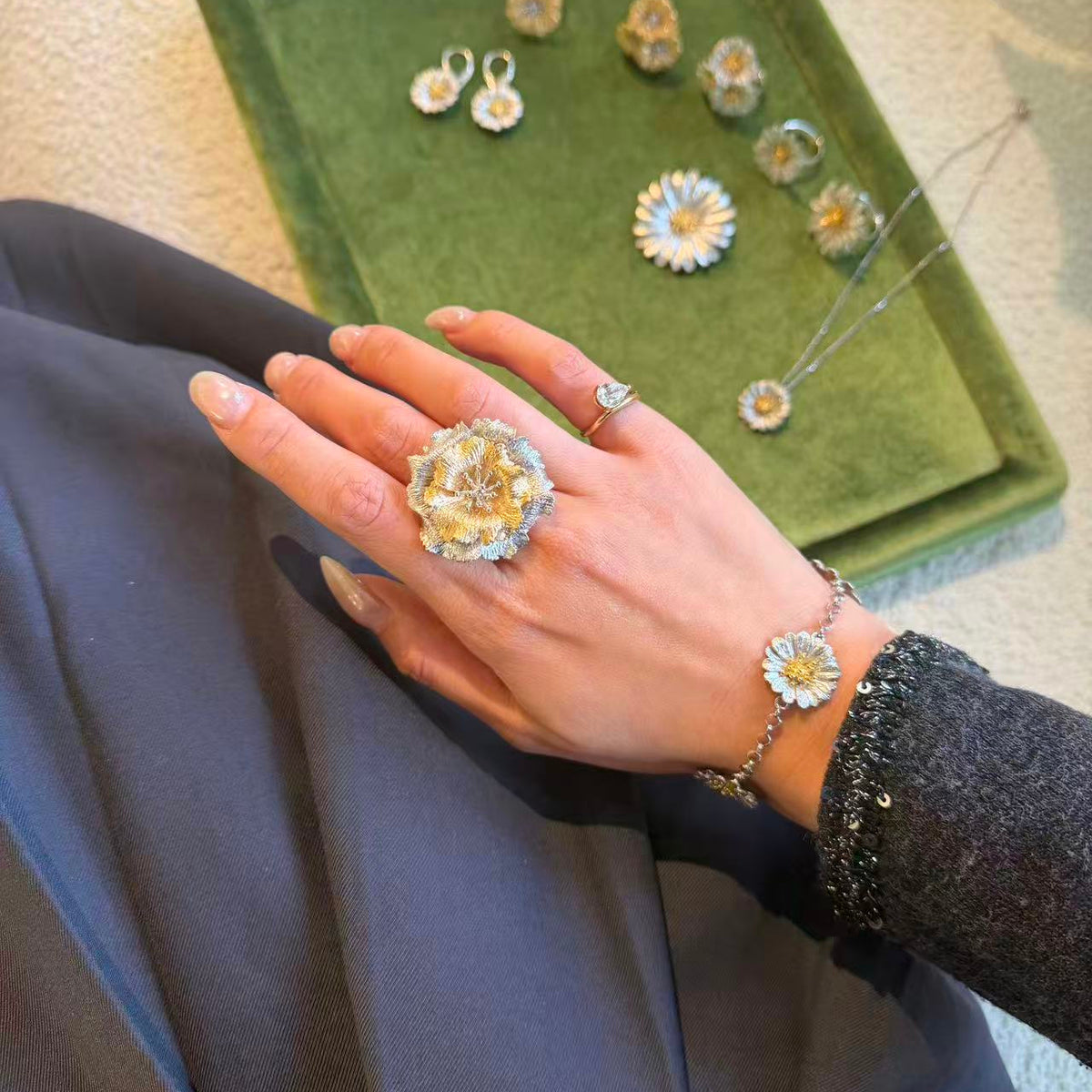 Italian silver floral statement brooch featuring layered textured silver petals and a warm gold-tone center, designed with elegant botanical detail.